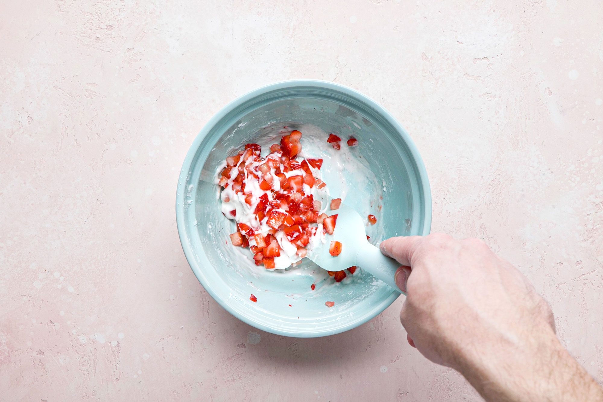 Whisk together the powdered sugar, lemon juice, milk and diced strawberries in a small bowl