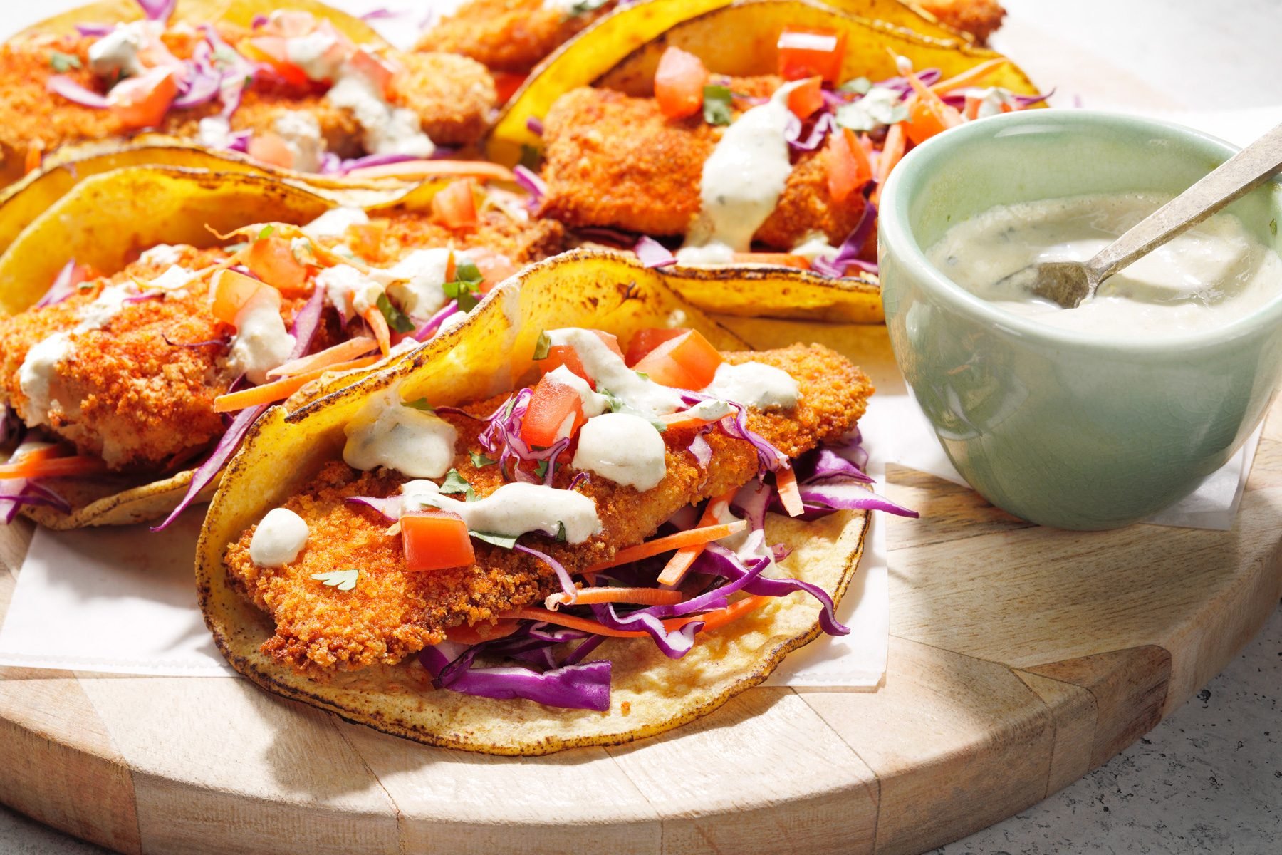 Air-fryer fish topped with tomatoes, shredded cabbage, and carrots