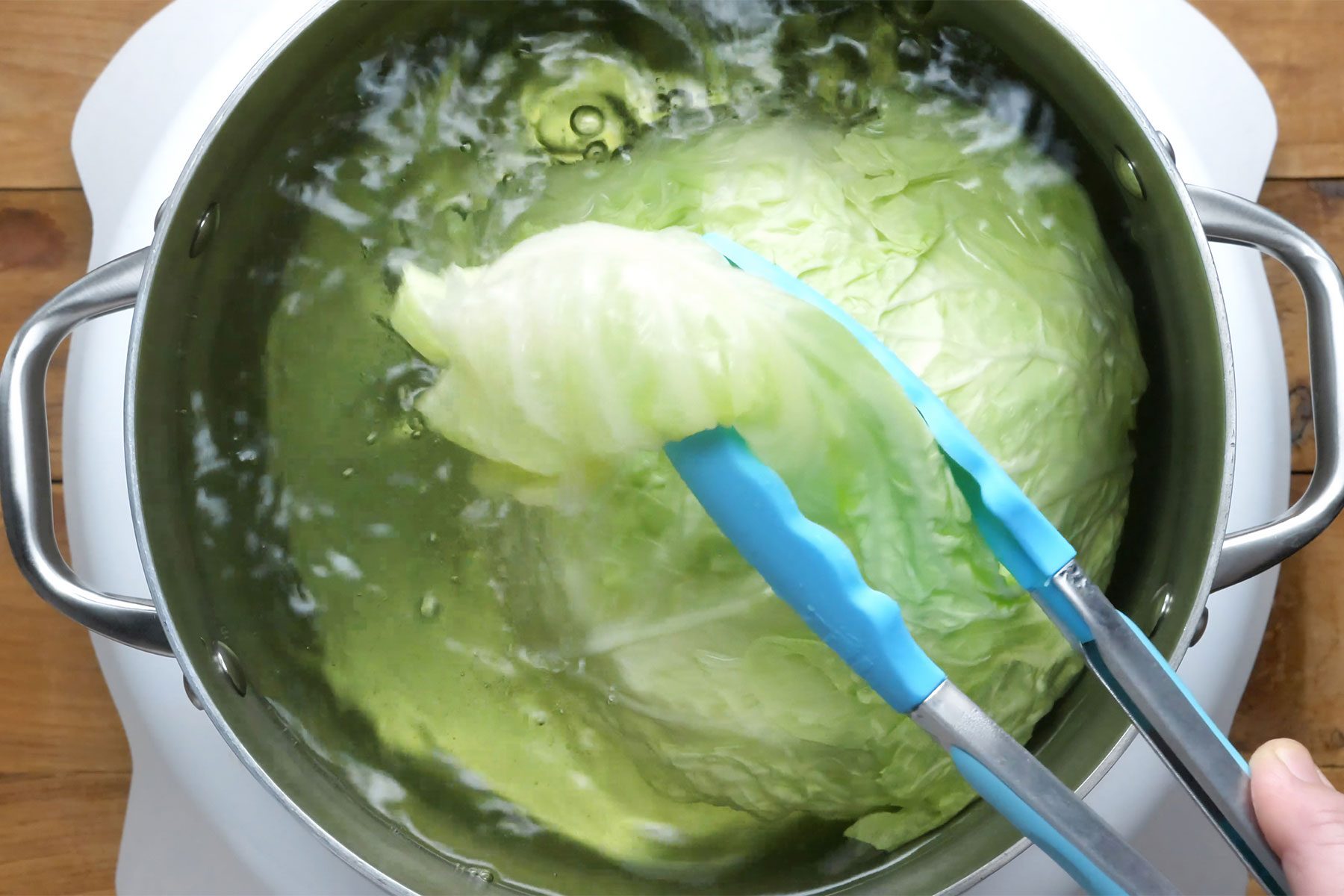 overhead shot of cabbage leaves in the boiling water