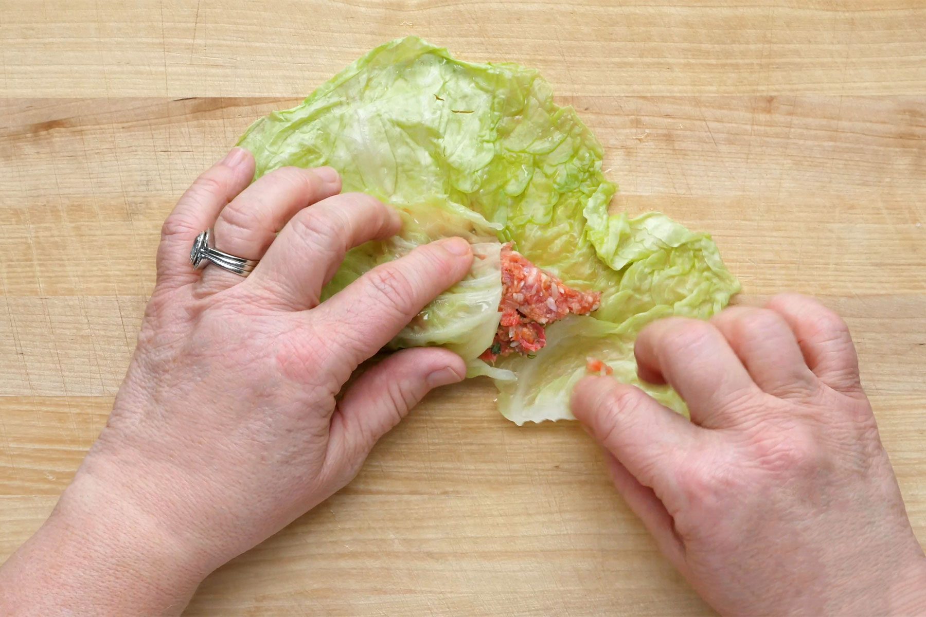 overhead shot of meat mixture rolled in cabbage leaf