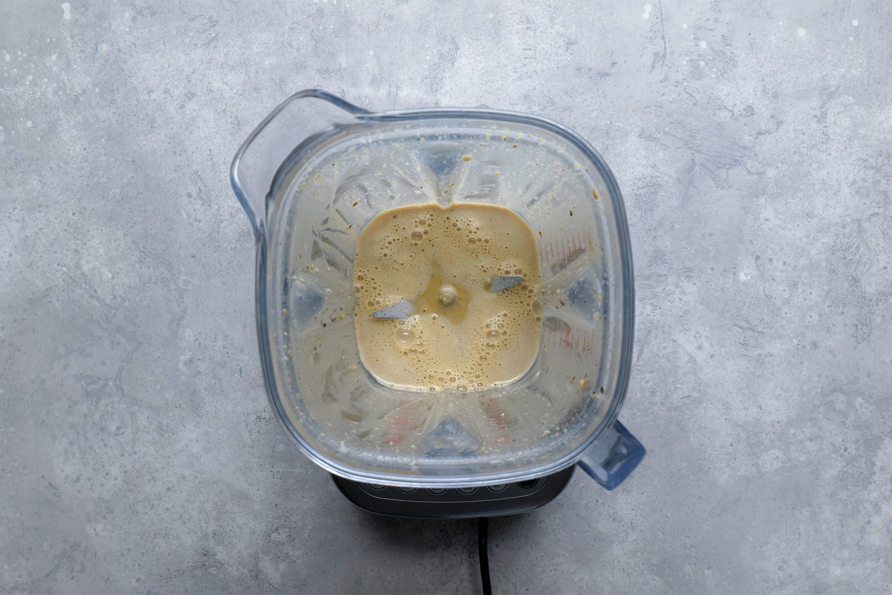 Overhead shot of place first 9 ingredients in a blender; cover and process until smooth; grey background