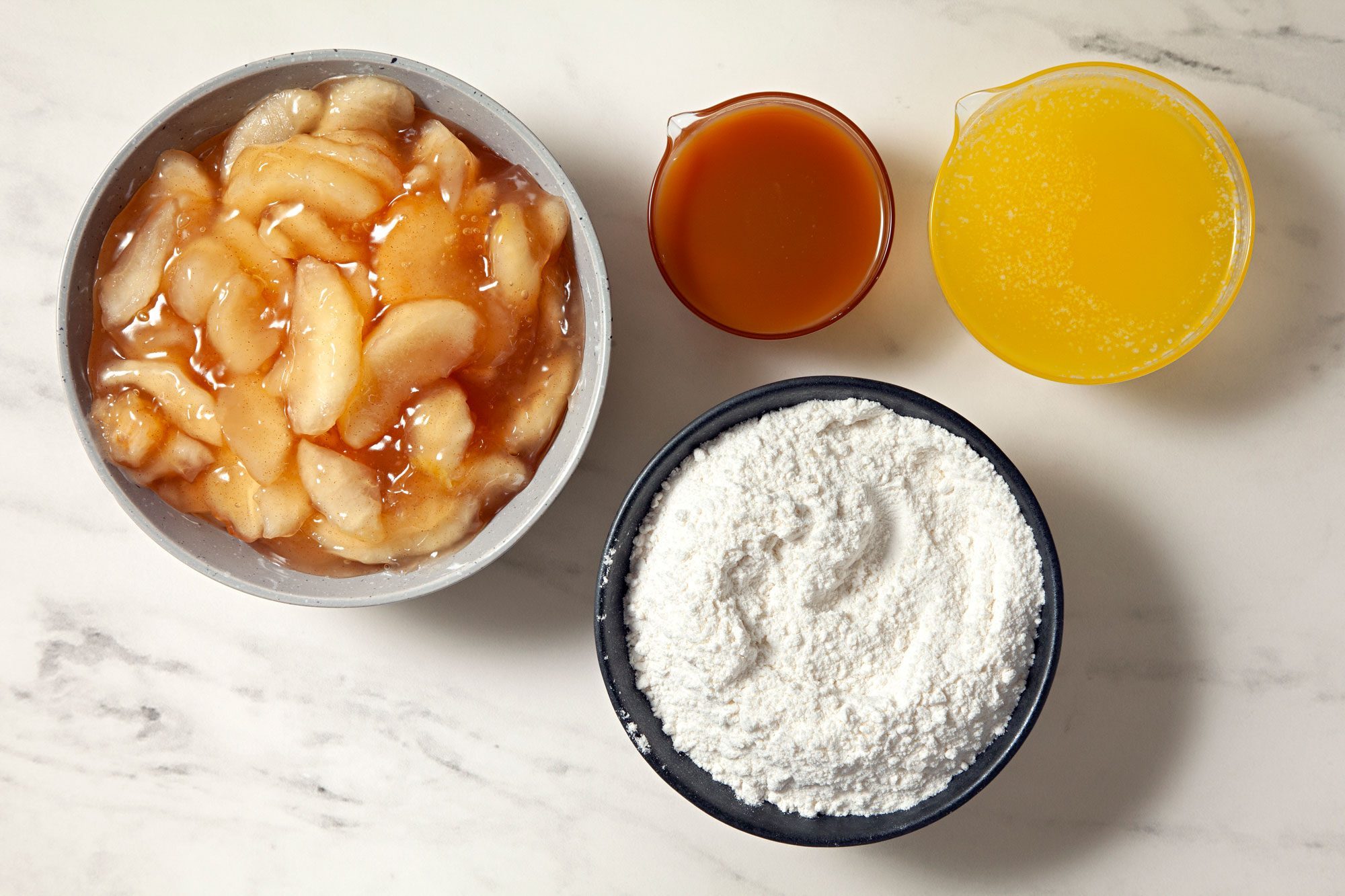 overhead shot of ingredients for Caramel Apple Dump Cake on a marble surface