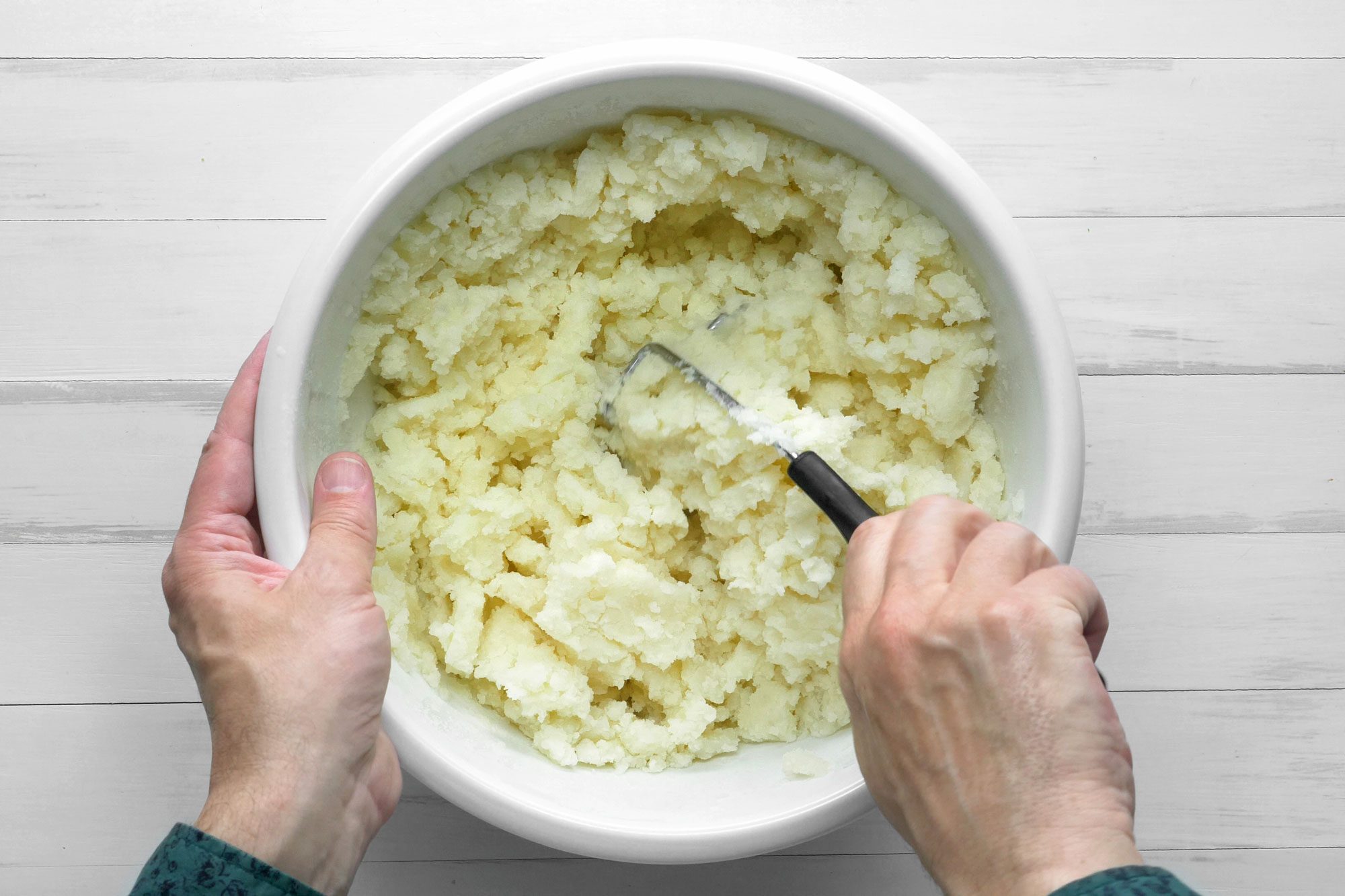 Mash the potatoes in a large bowl