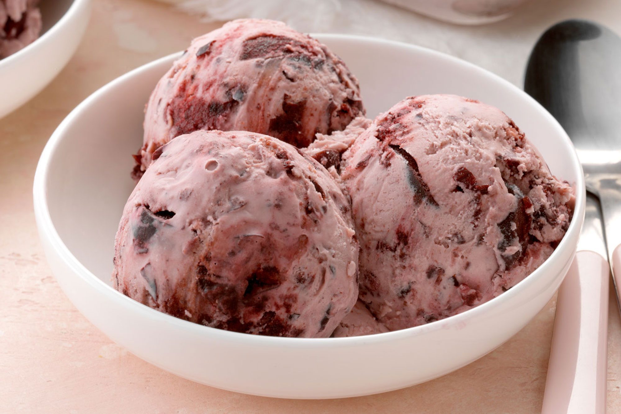 Delicious Cherry Nut Ice Cream in a bowl with a spoon