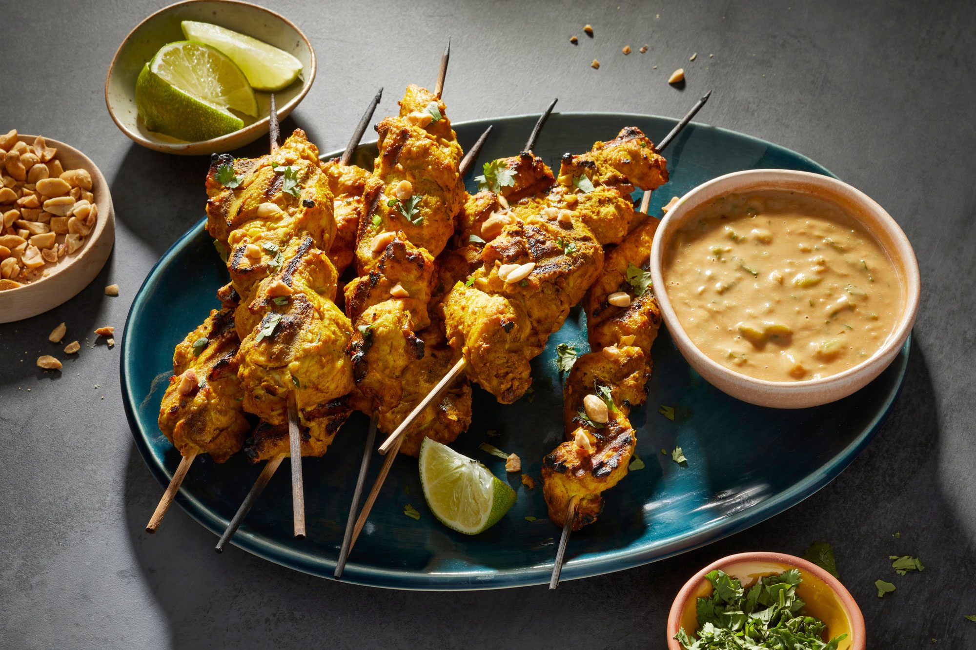 3/4th Shot of Chicken Satay with Peanut Sauce Served on an Oval Shaped Plate