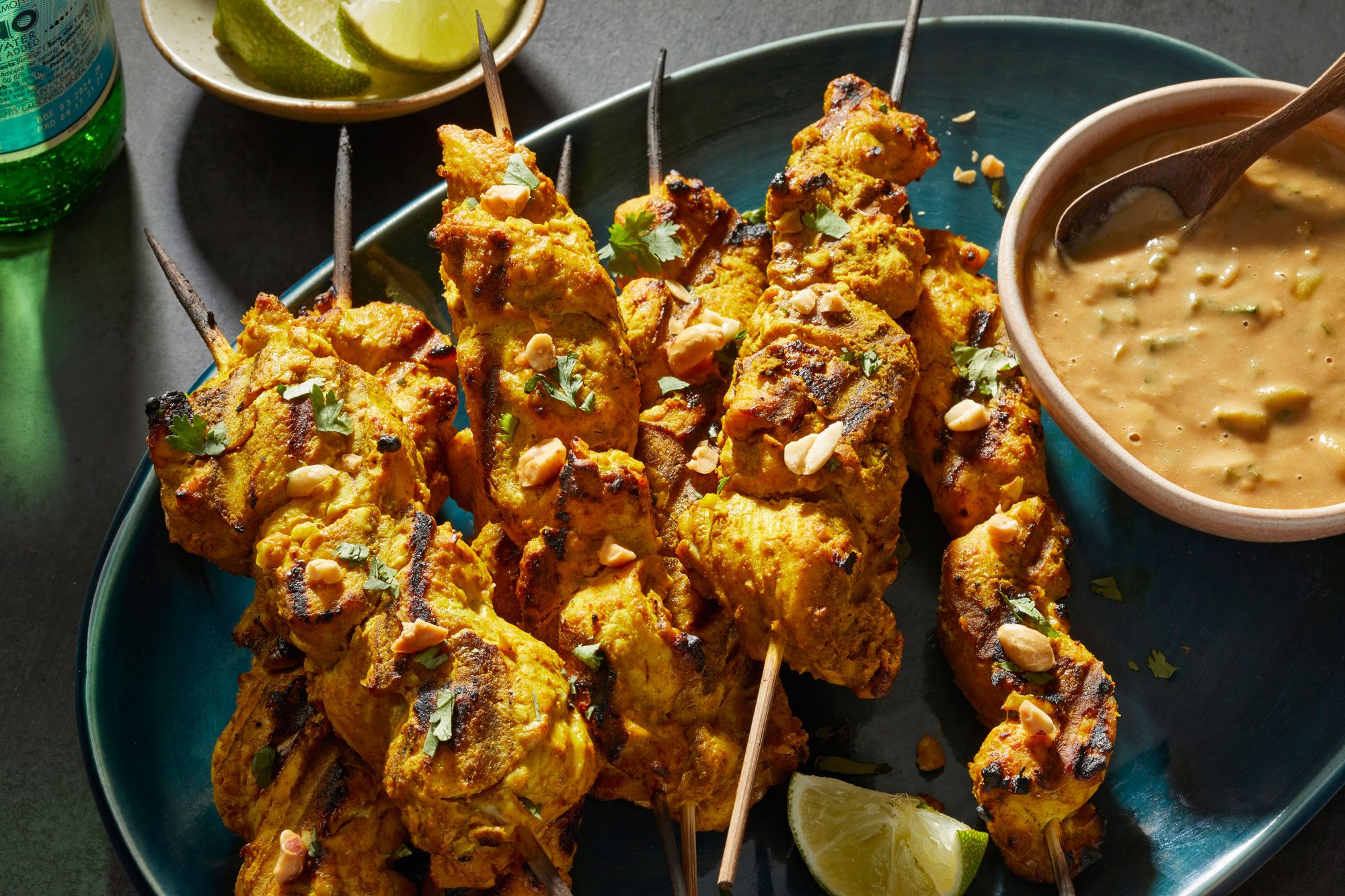 Close Shot of Chicken Satay with Peanut Sauce Served on an Oval Shaped Plate