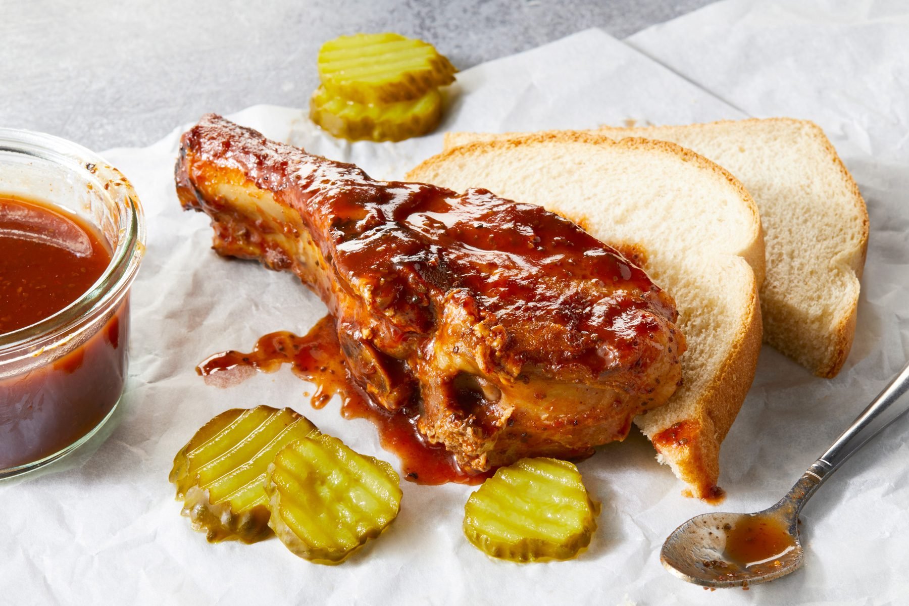 A piece of Country Style Grilled Ribs served with baked potatoes