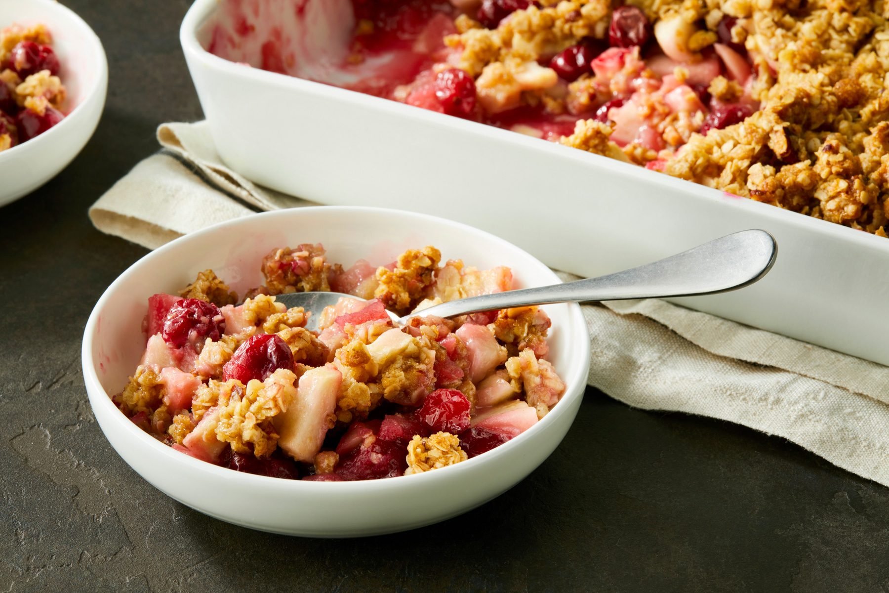 A bowl of Cranberry Apple Crisp with a spoon