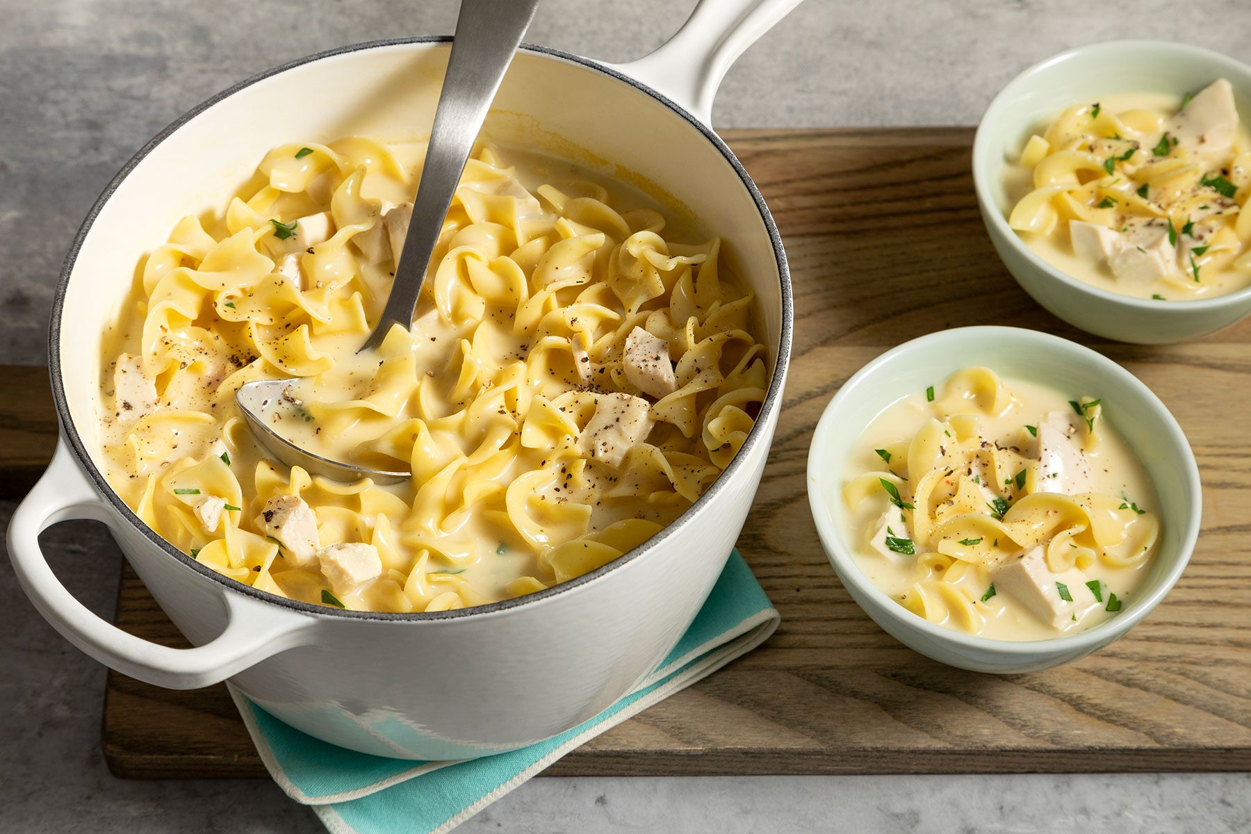 wide shot of chicken noodle soup in a pan