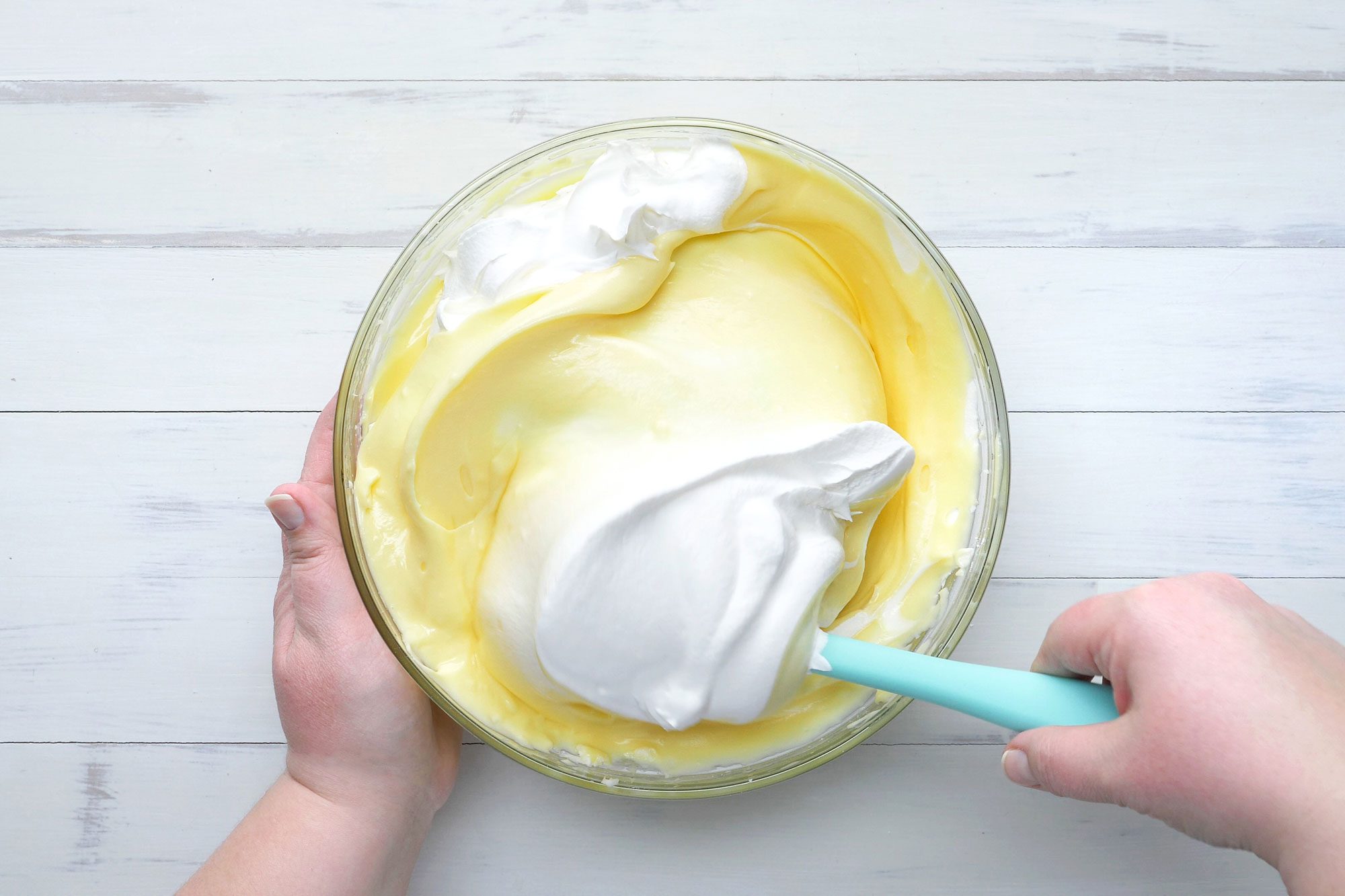 overhead shot; white background; Gradually stir into cream cheese mixture, Fold in whipped topping;