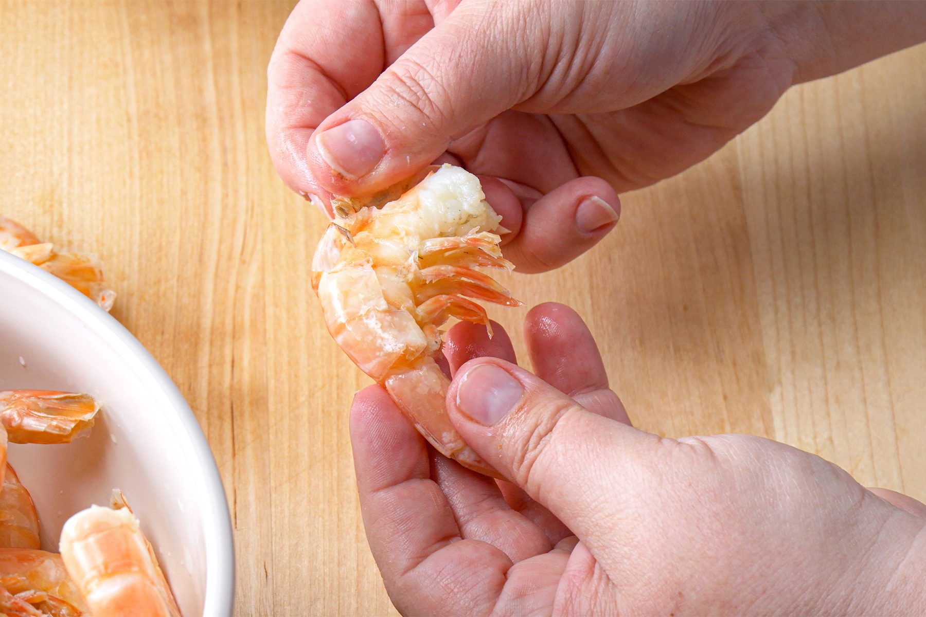 Peeling shrimps with hands