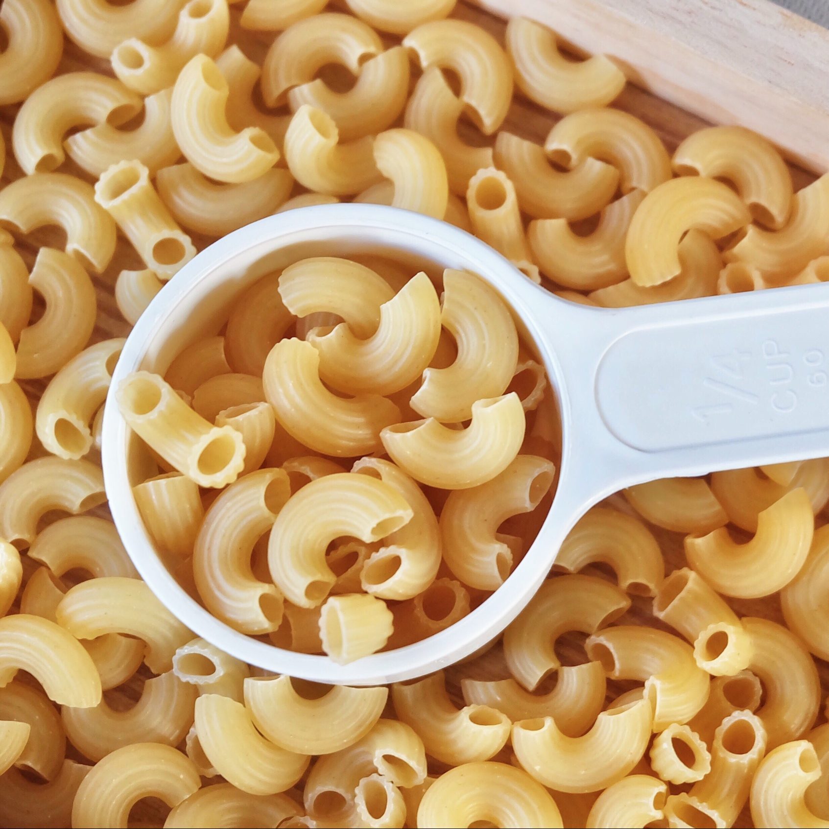 Dried Elbow Macaroni in A Measuring Cup