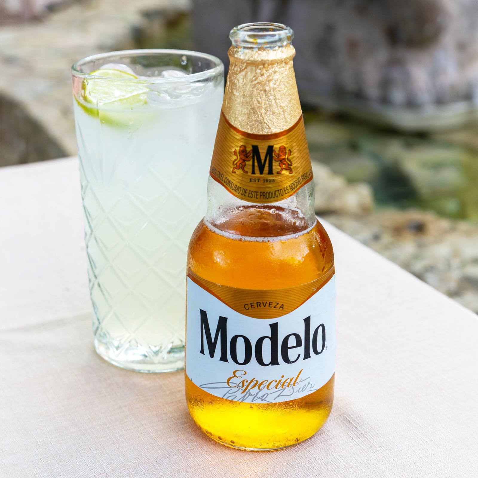 Bottle of Modelo Especial cerveza beer and Mojito in glass on table, Vallodolid, Yucatan, Mexico