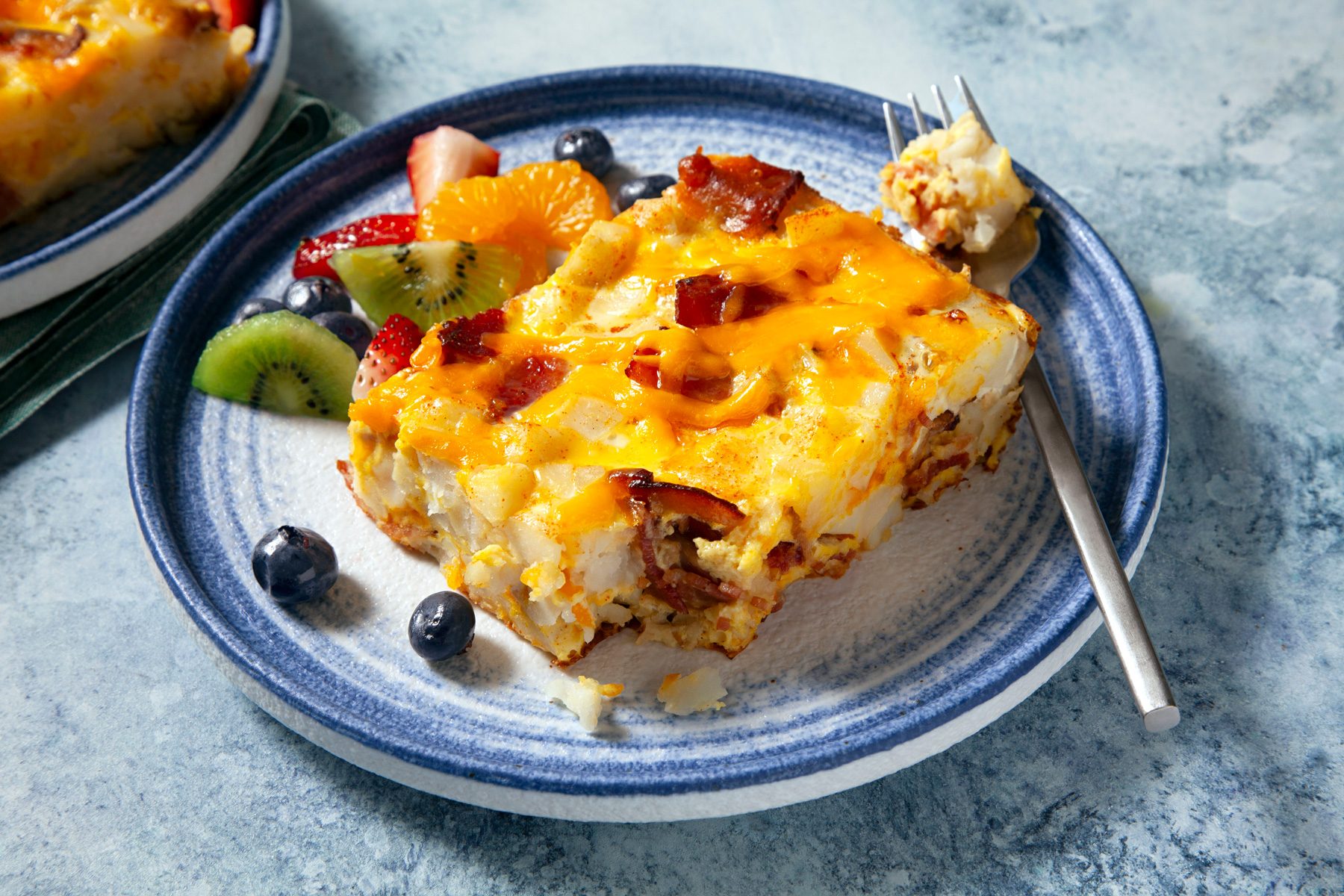 A plate of Hash Brown Egg Bake with a spoon