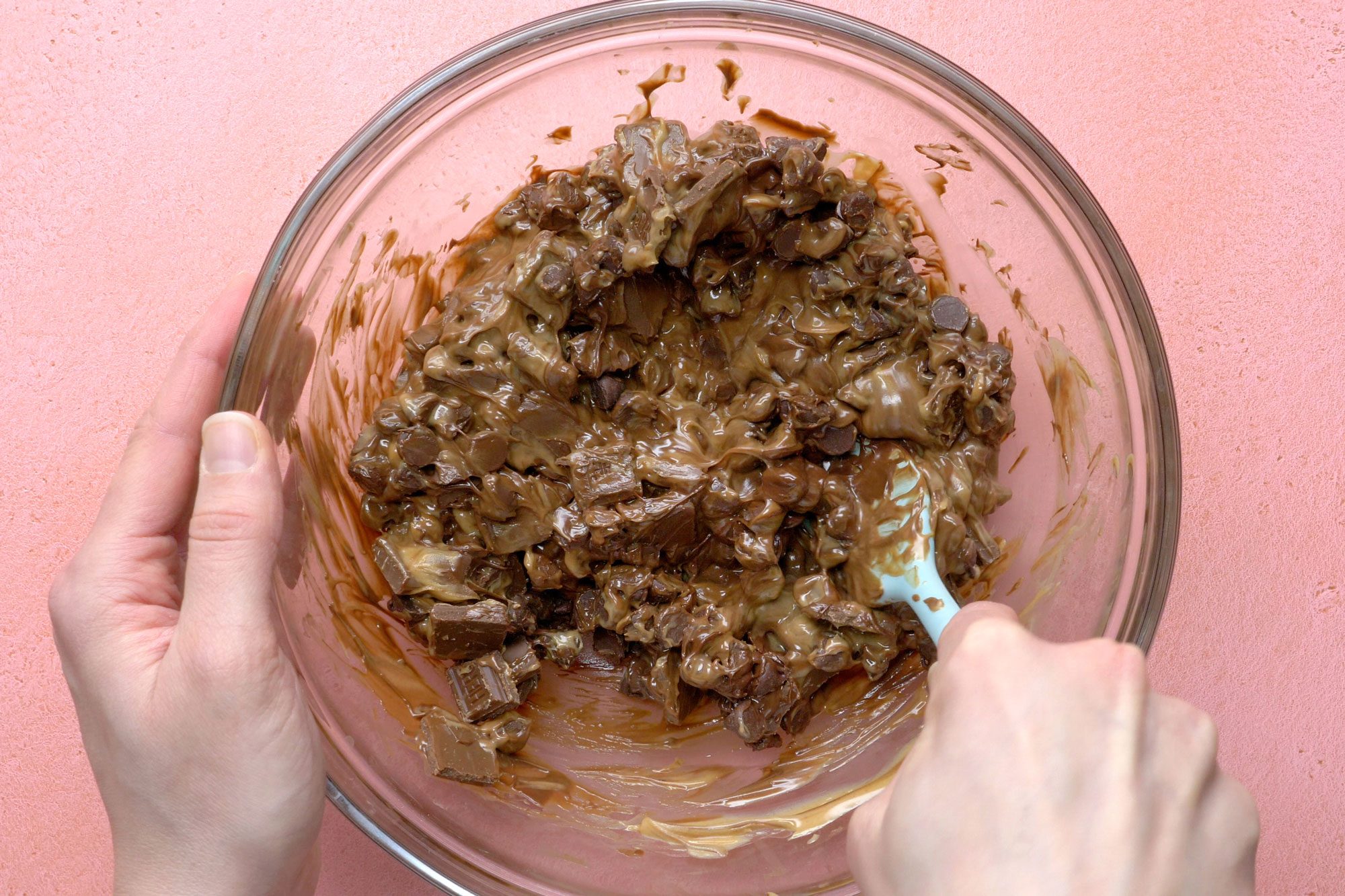 Mix melted chocolate chips, candy bars and remaining peanut butter in a large bowl
