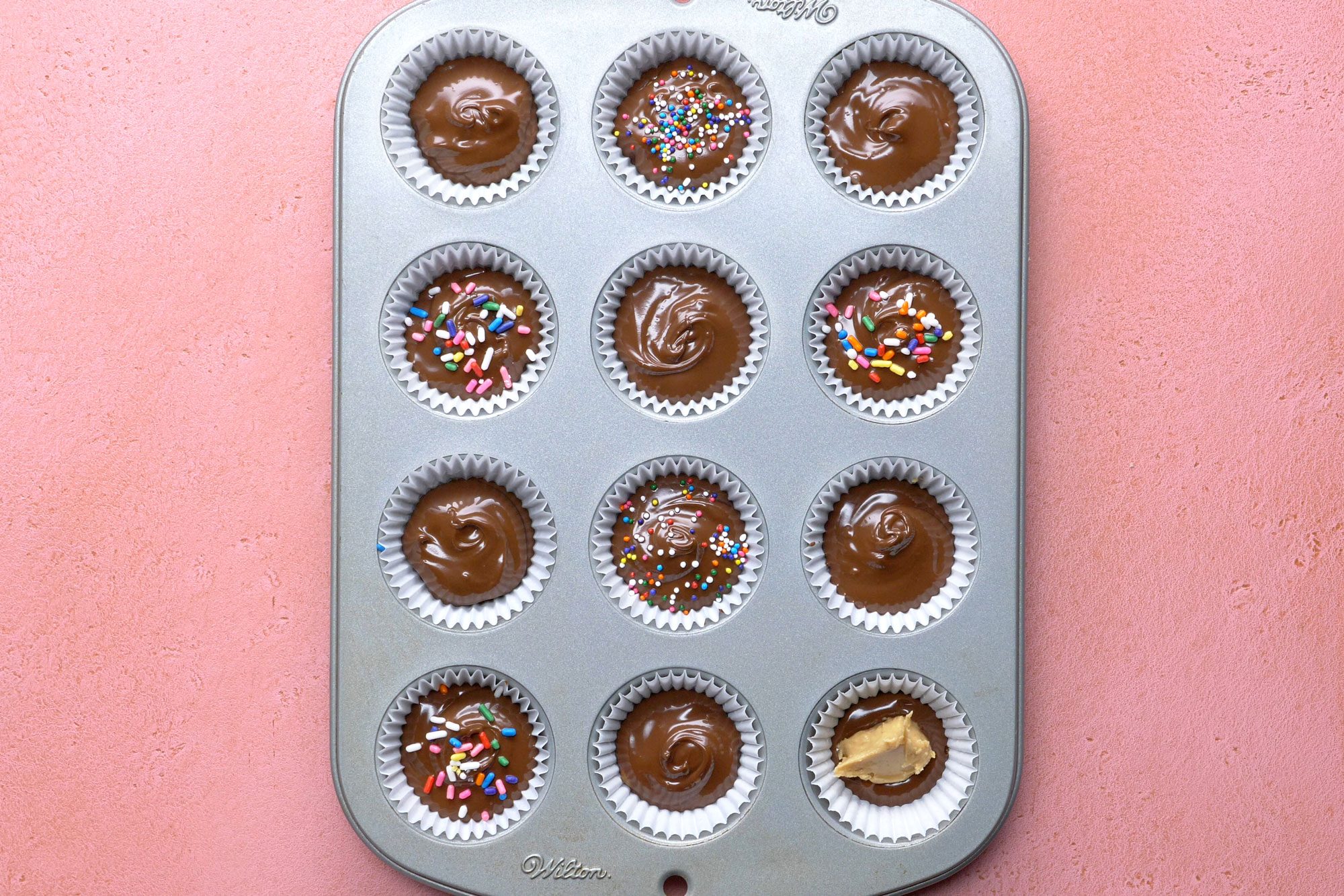 Drop the chocolate mixture into paper-lined mini muffin cups and decorate with sprinkles