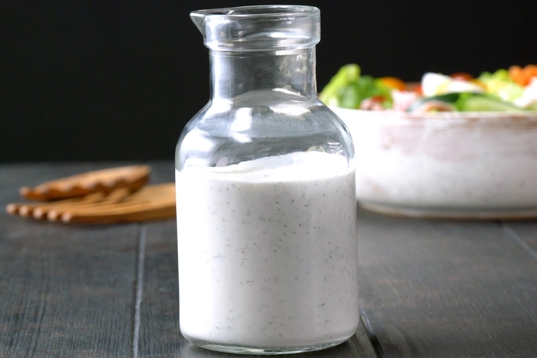A glass container of Homemade Ranch Dressing