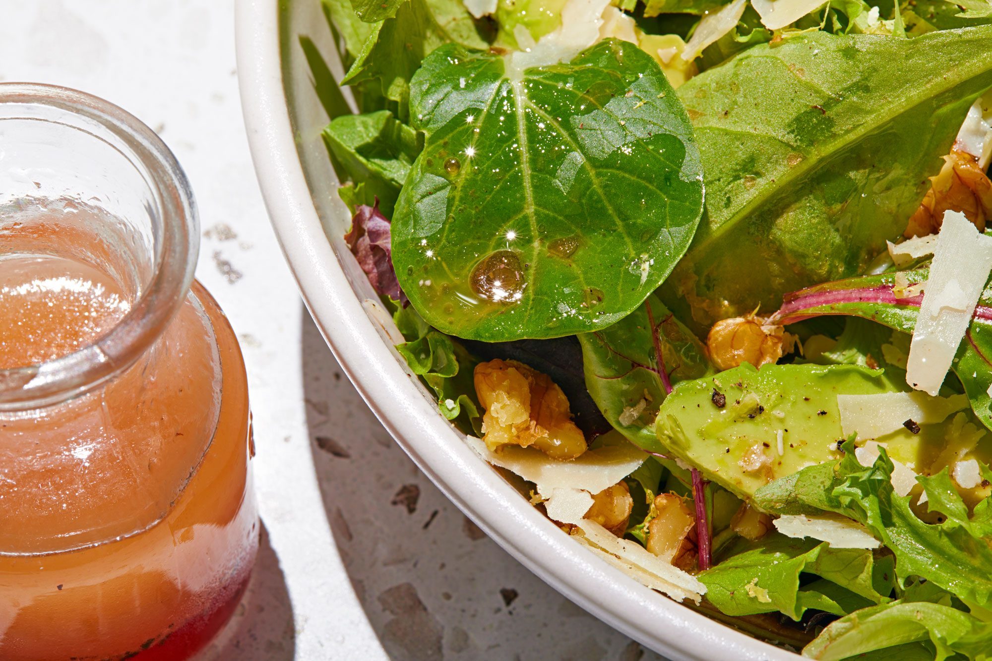 Oil and Vinegar Dressing sprinkled over salad in a bowl