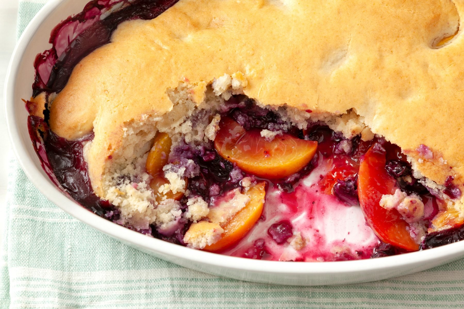 A plate of Peach Blueberry Cobbler on a table