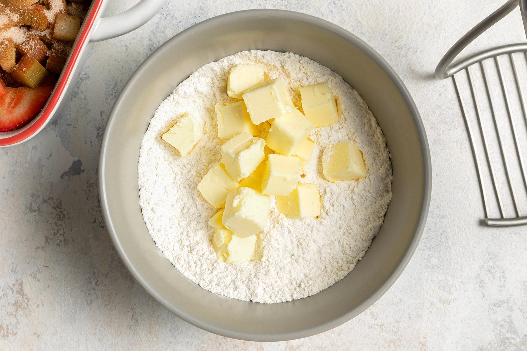 overhead shoyt of butter added in the flour mixture