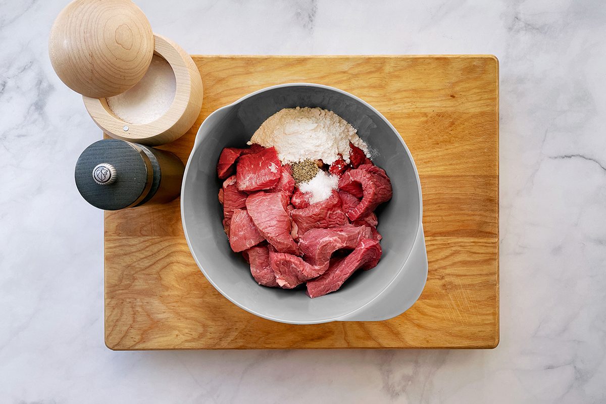 How to make Taste of Home's Round Steak recipe, step one with ingredients in a mixing bowl