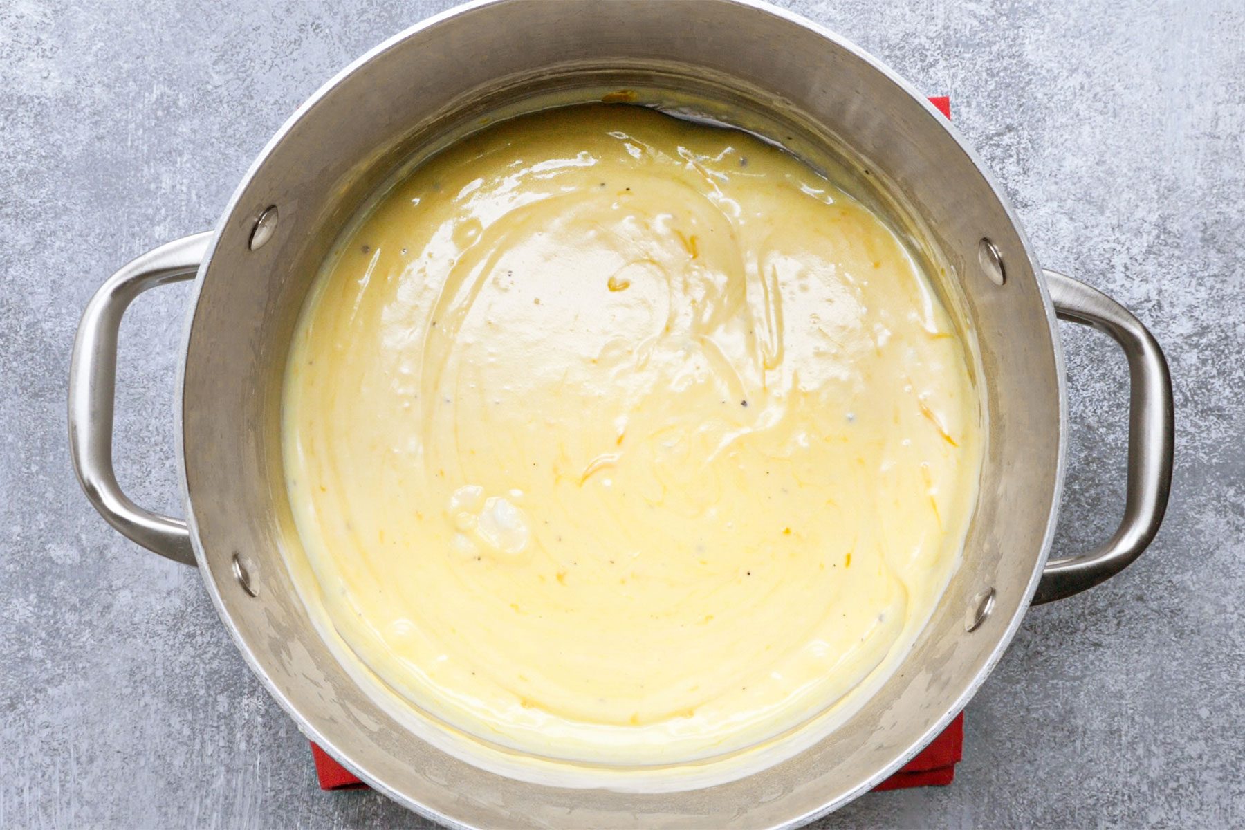 overhead shot of cheese melted in a large saucepan