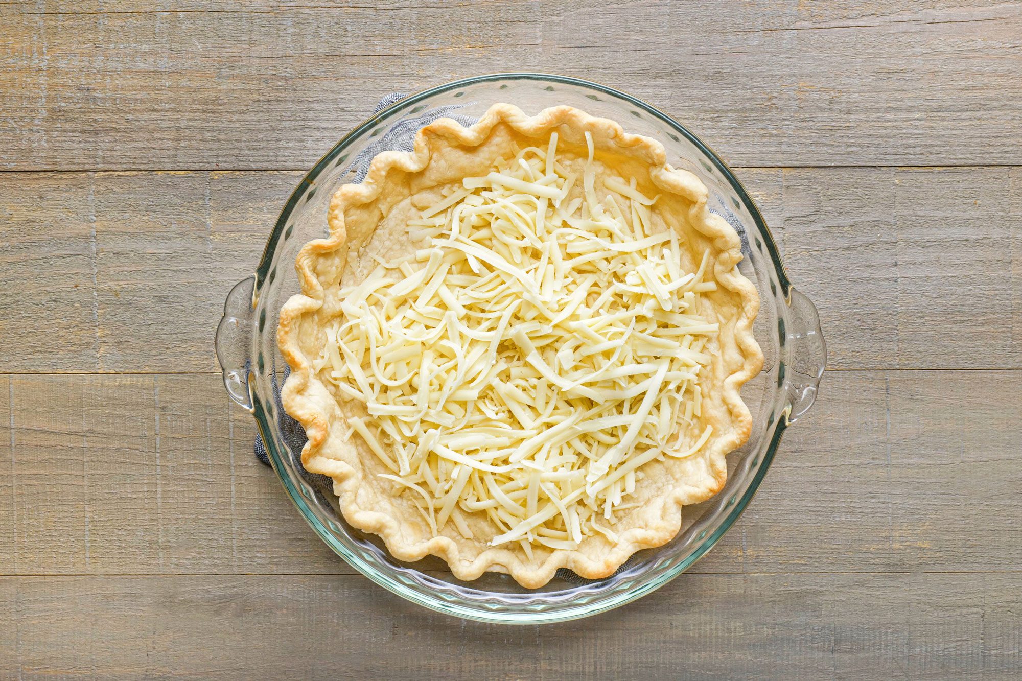 Sprinkle the cheese into the pie crust