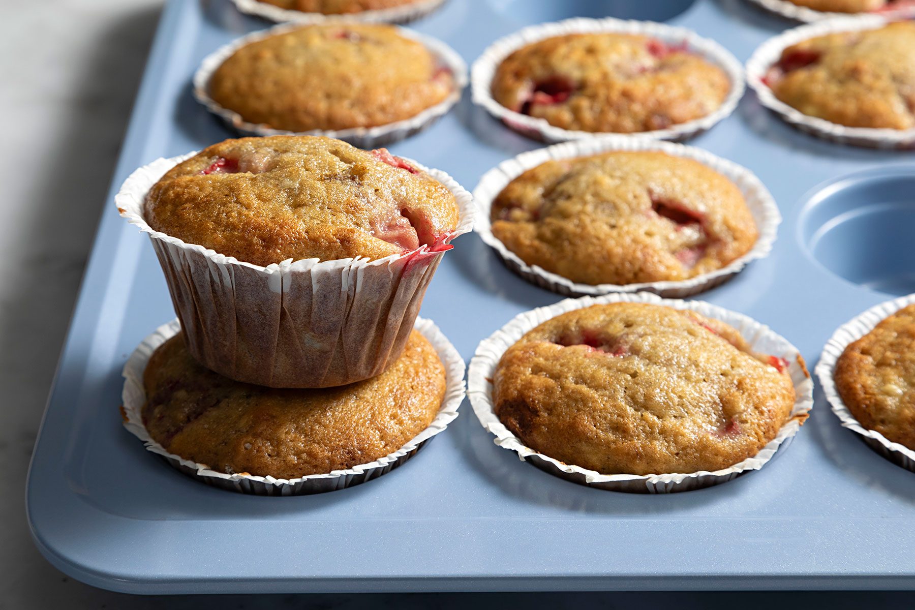 wide shot of baked strawberry banana muffins