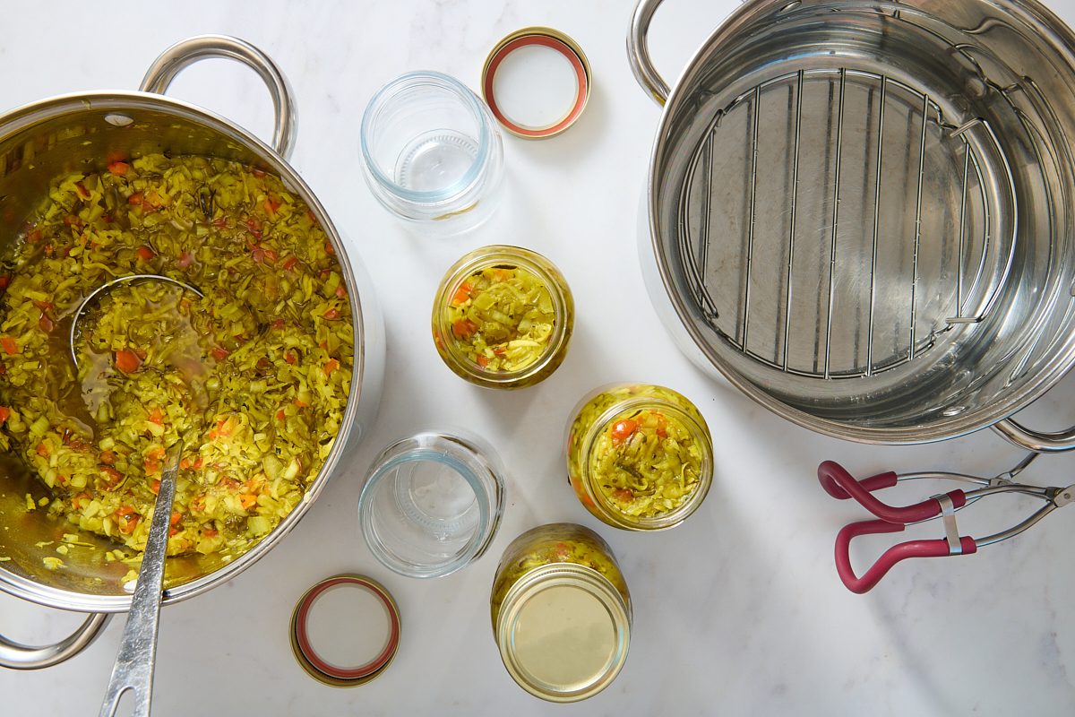 Sweet zucchini relish being filled into canning jars