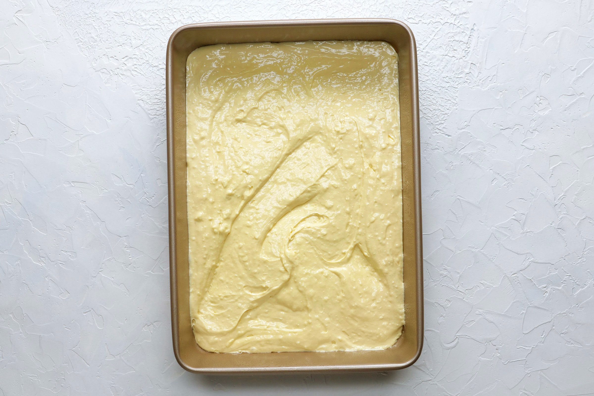 Tres leches cake batter in a pan before baking