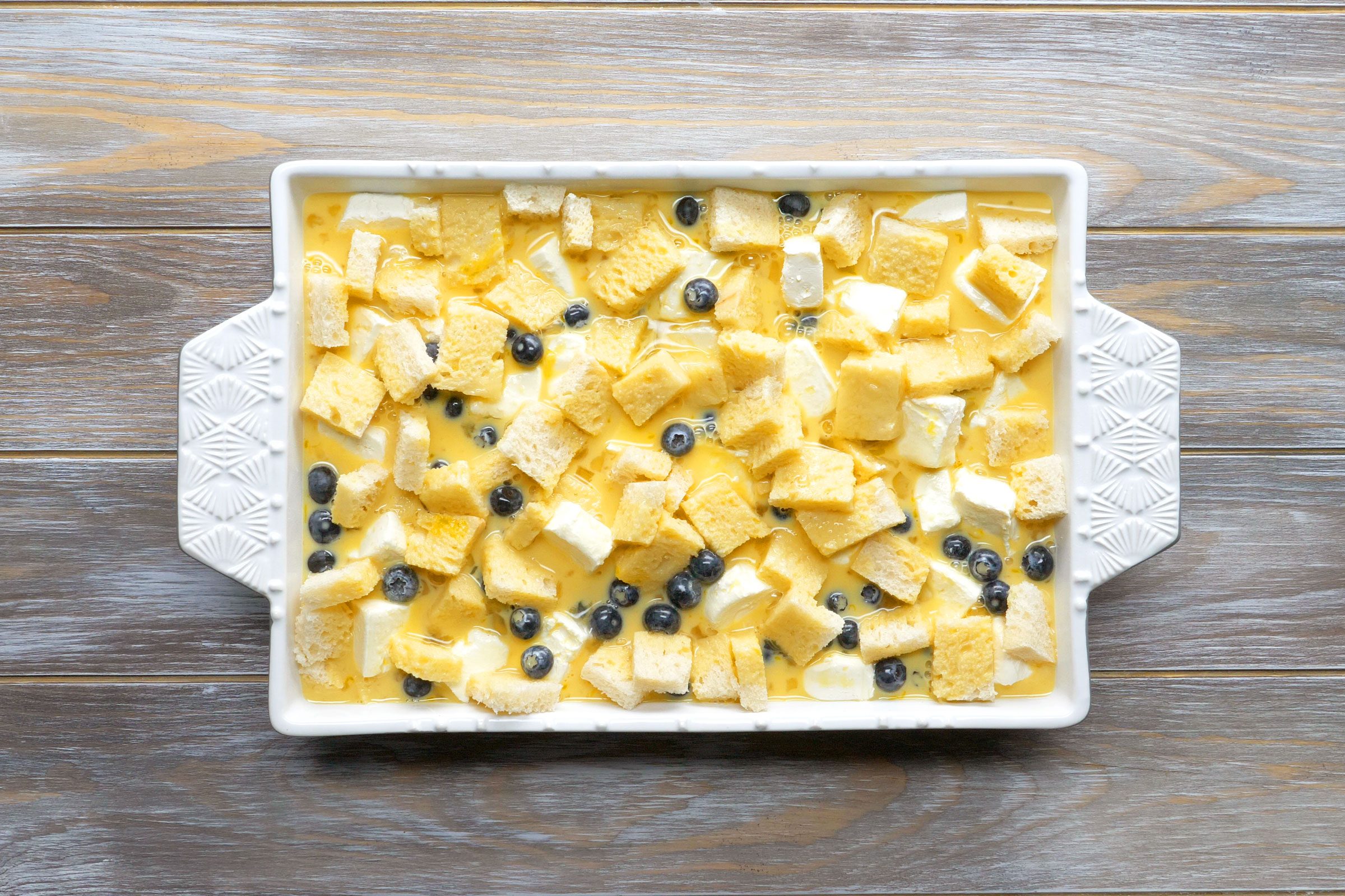  13x9-inch baking dish with blueberry french toast before baking