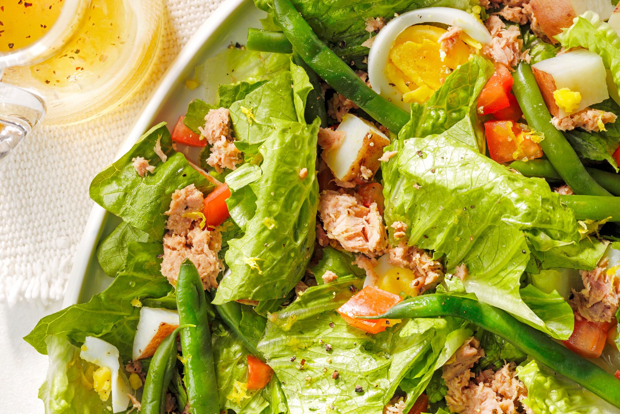 Plate of Tuna Nicoise salad with meat, veggies, and eggs
