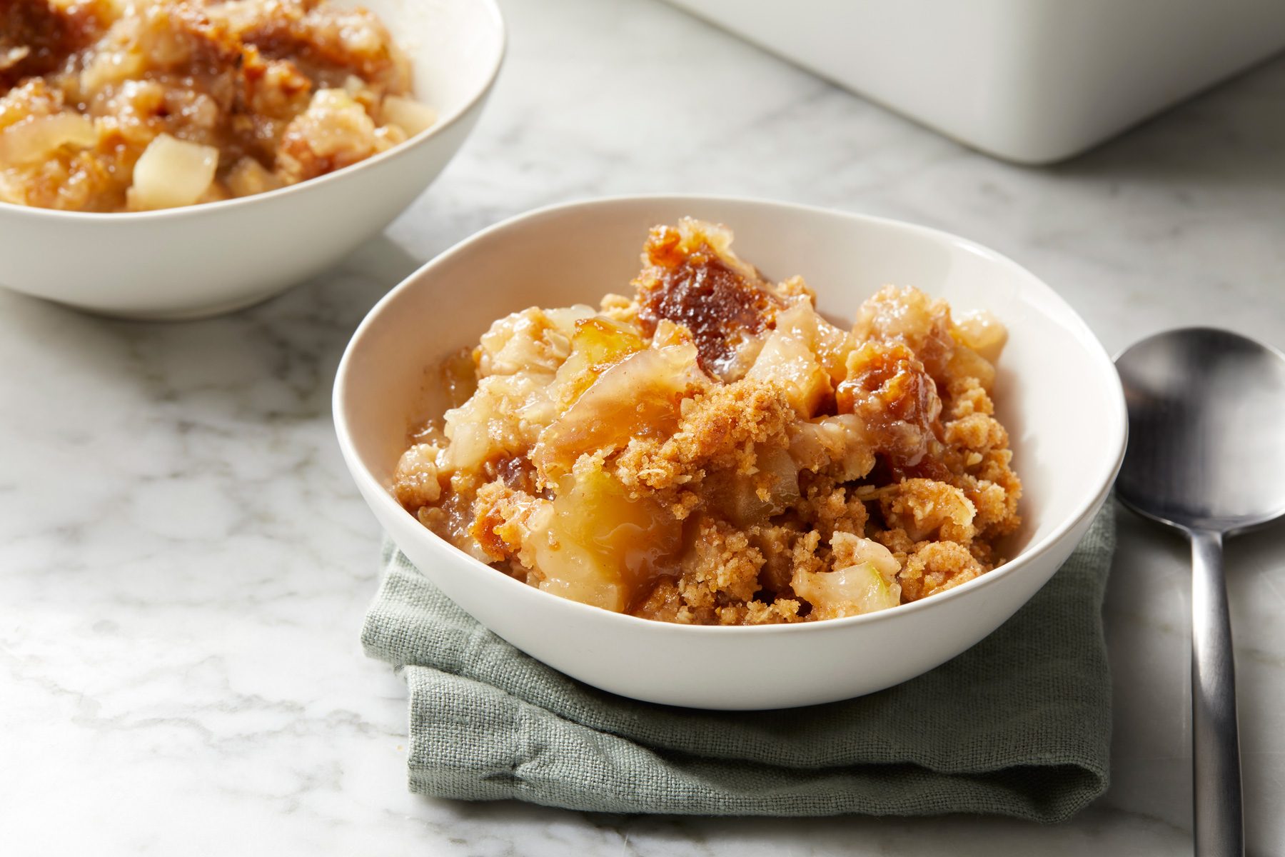 Two bowls of Winning Apple Crisp on a table
