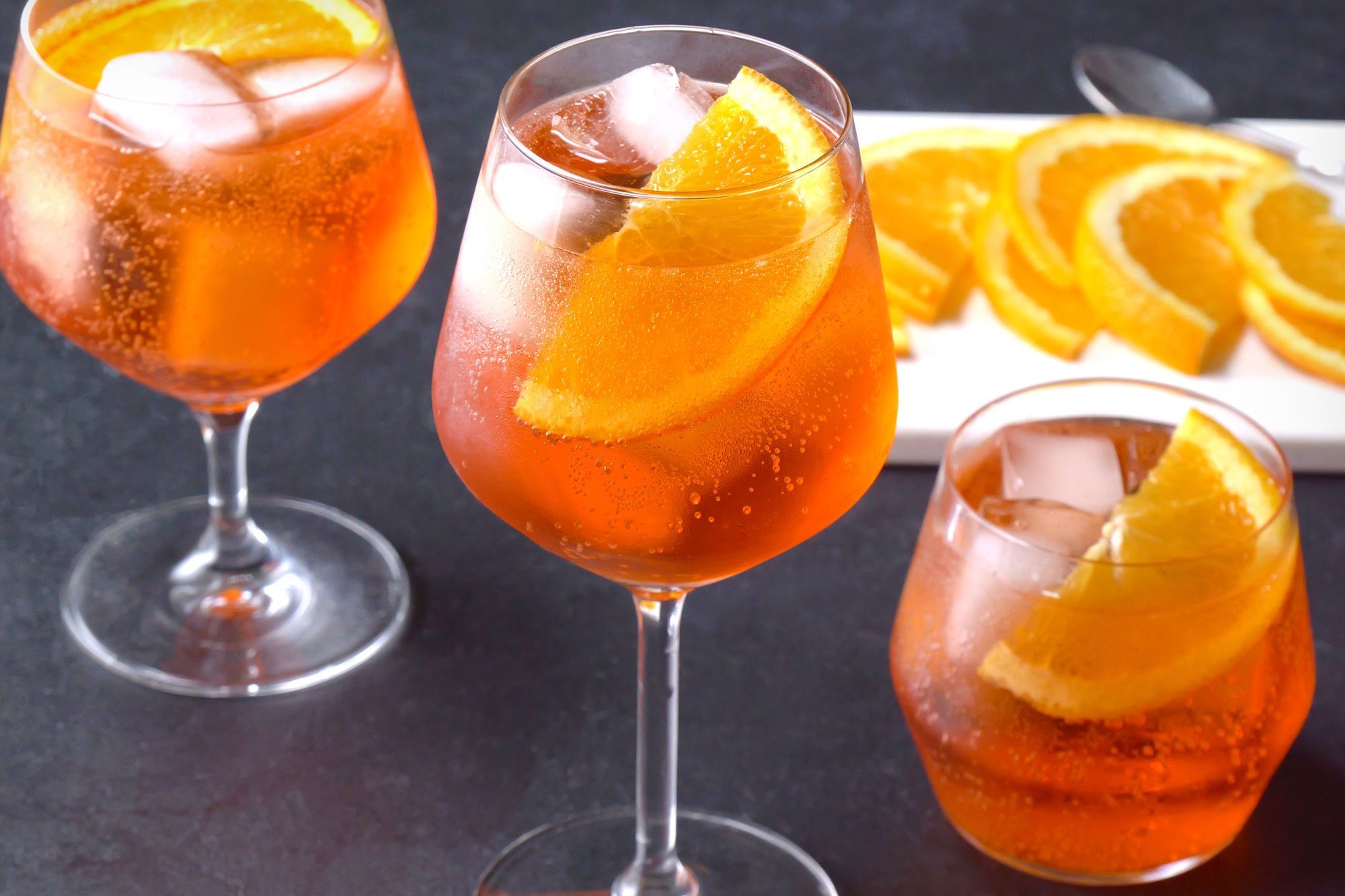 high angle shot of aperol spritz served with orange slices