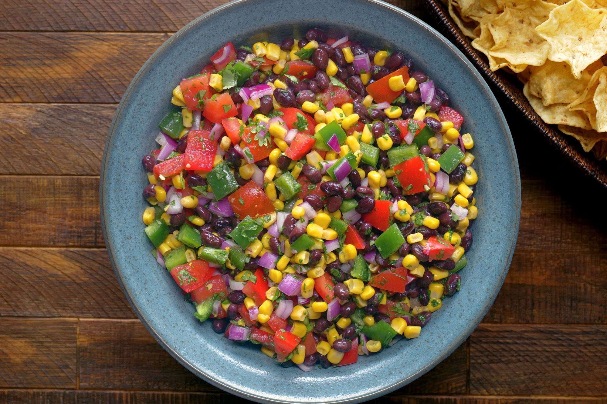 Black Bean And Corn Salsa served in a bowl with tortilla chips