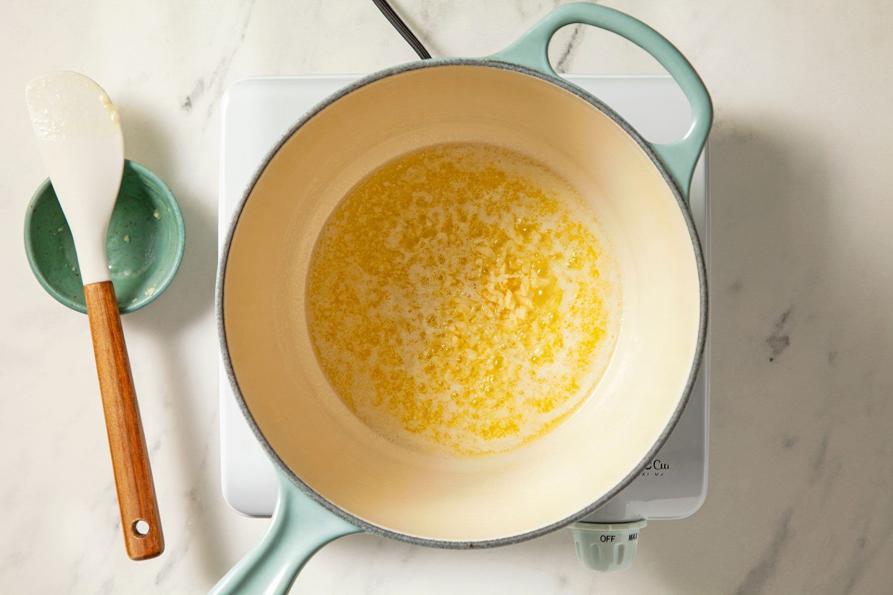 overhead shot of melted butter with garlic in a saucepan