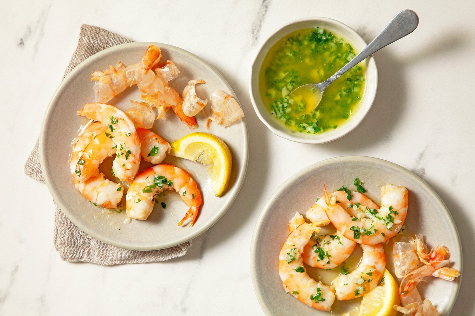 high angle shot of boiled shrimps served with garlic butter