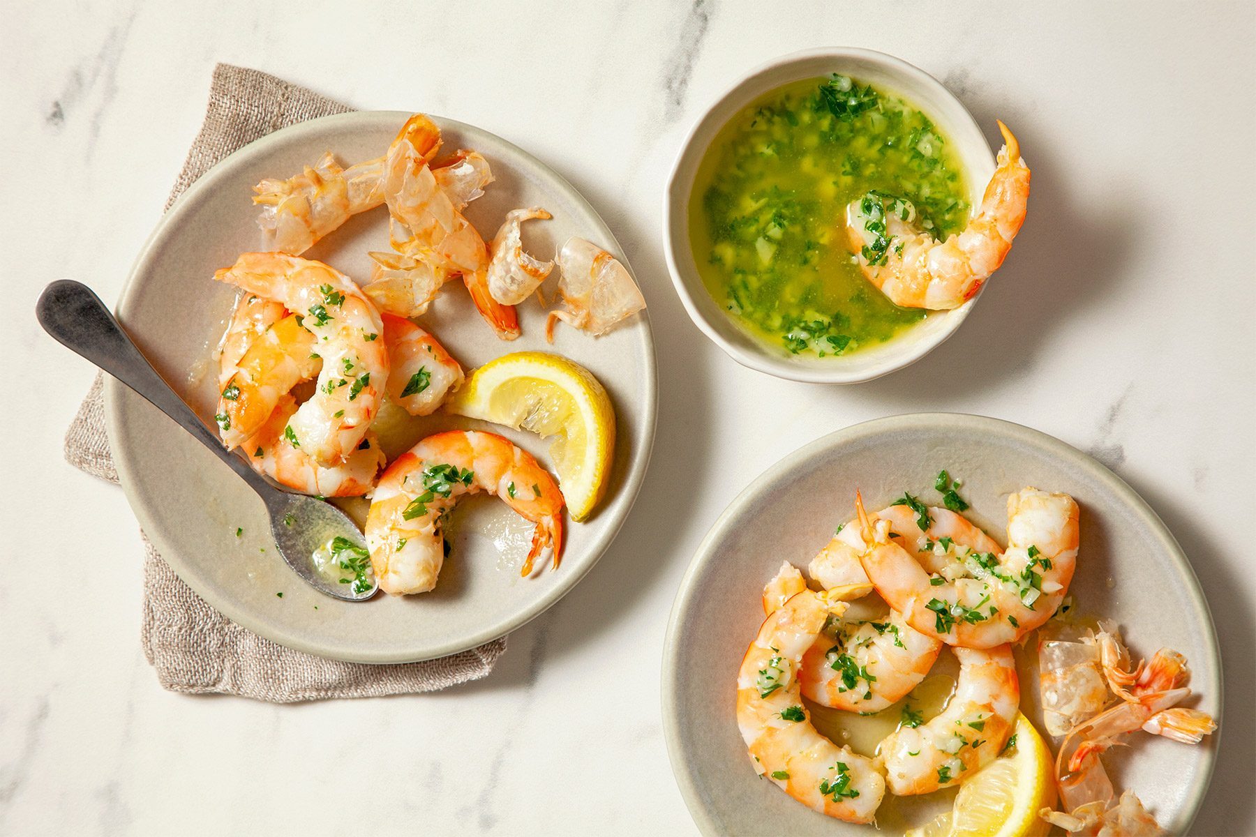 overhead shot of boiled shrimps served with garlic butter