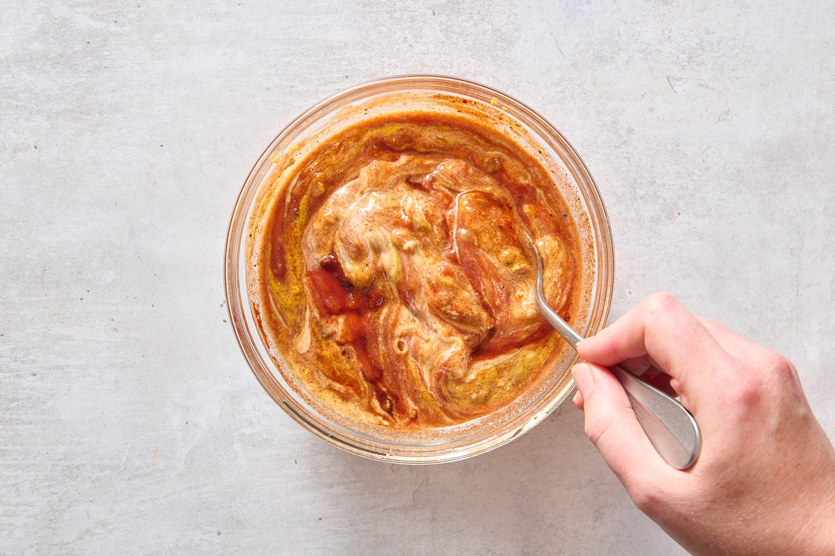 Combining burger sauce ingredients in a small bowl