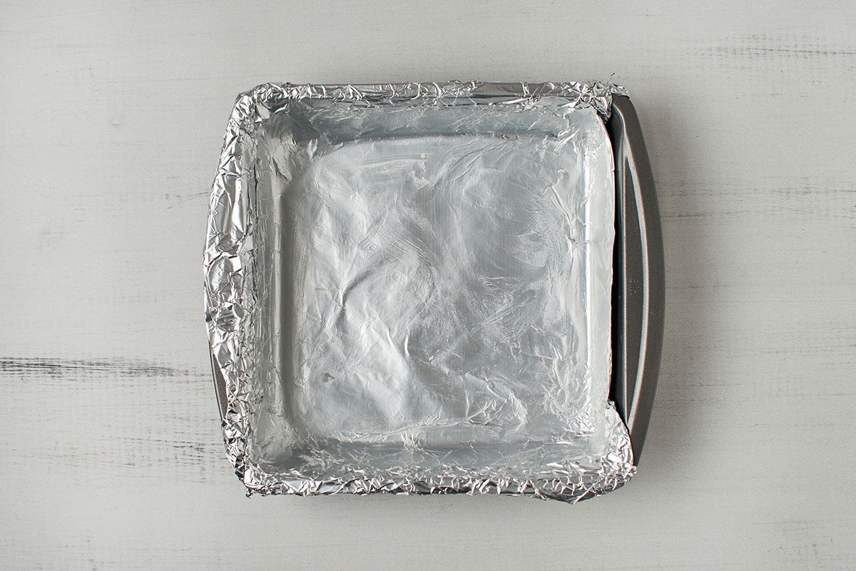 Grease square pan with foil and butter