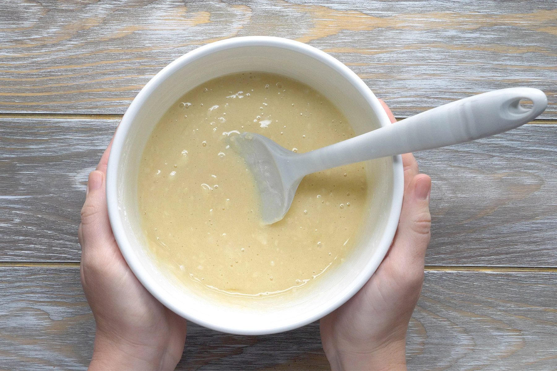 overhead shot; wooden background; In a small white bowl, combine the remaining sugar with flour, baking powder, salt, milk and egg;