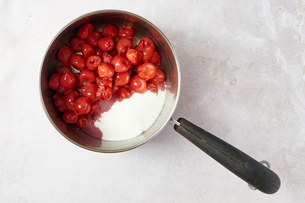 Cherries and sugar in a saucepan for the filling for Cherry Cobbler