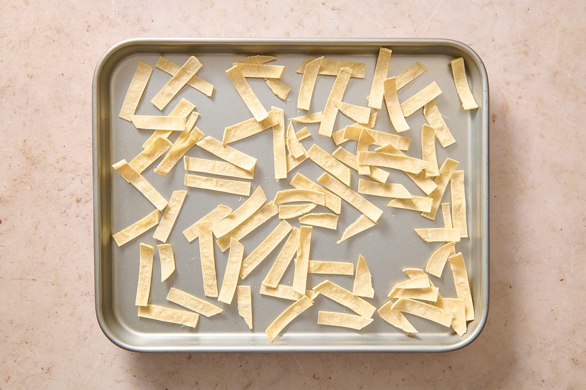 Tortilla strips laid out on a baking tray