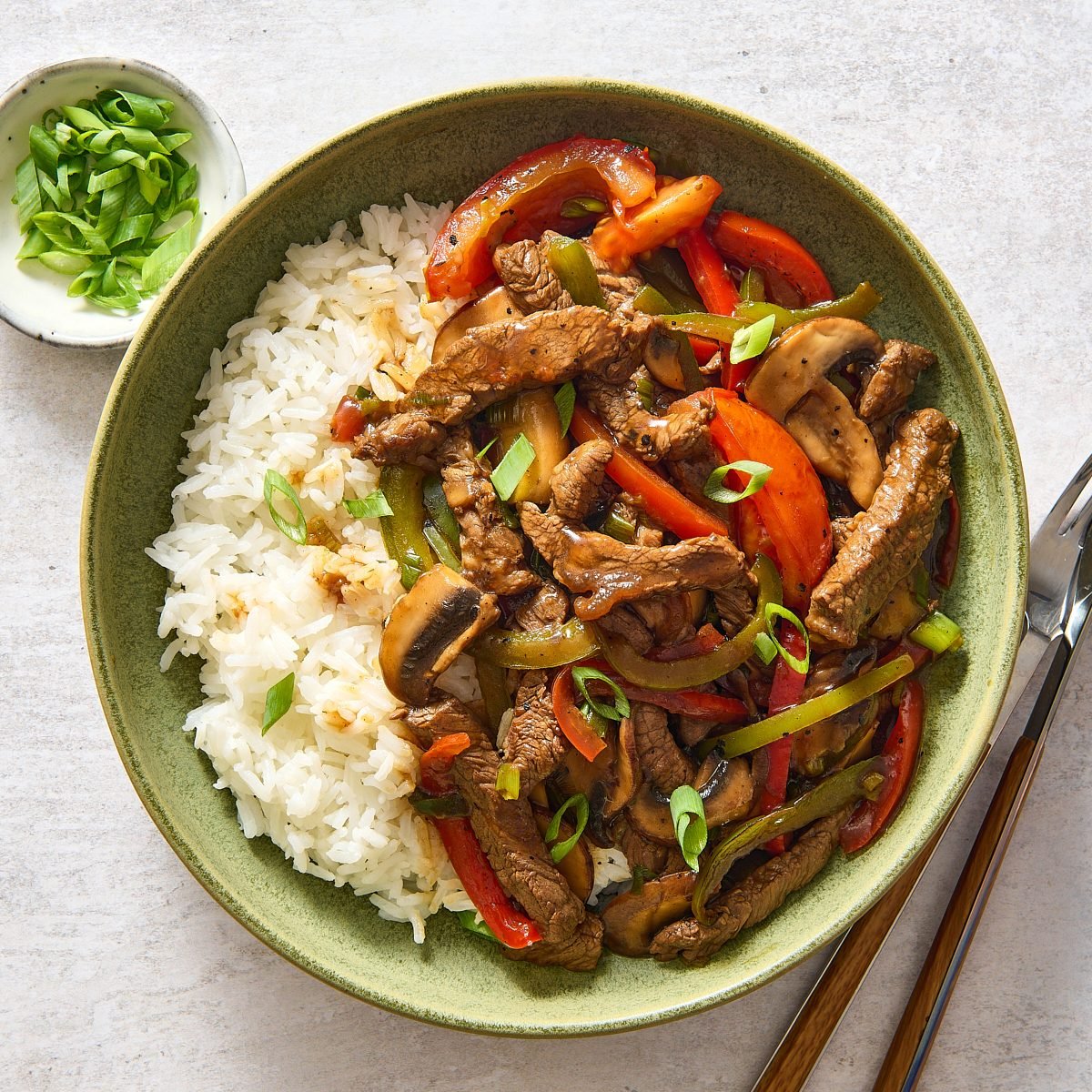 Overhead image of a bowl of Chinese pepper steak with rice