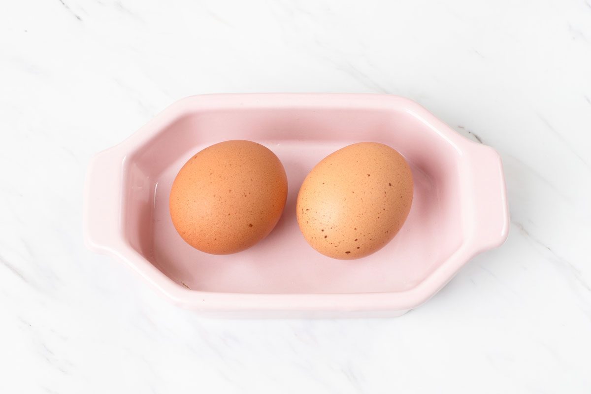 eggs in a pink dish on a kitchen counter