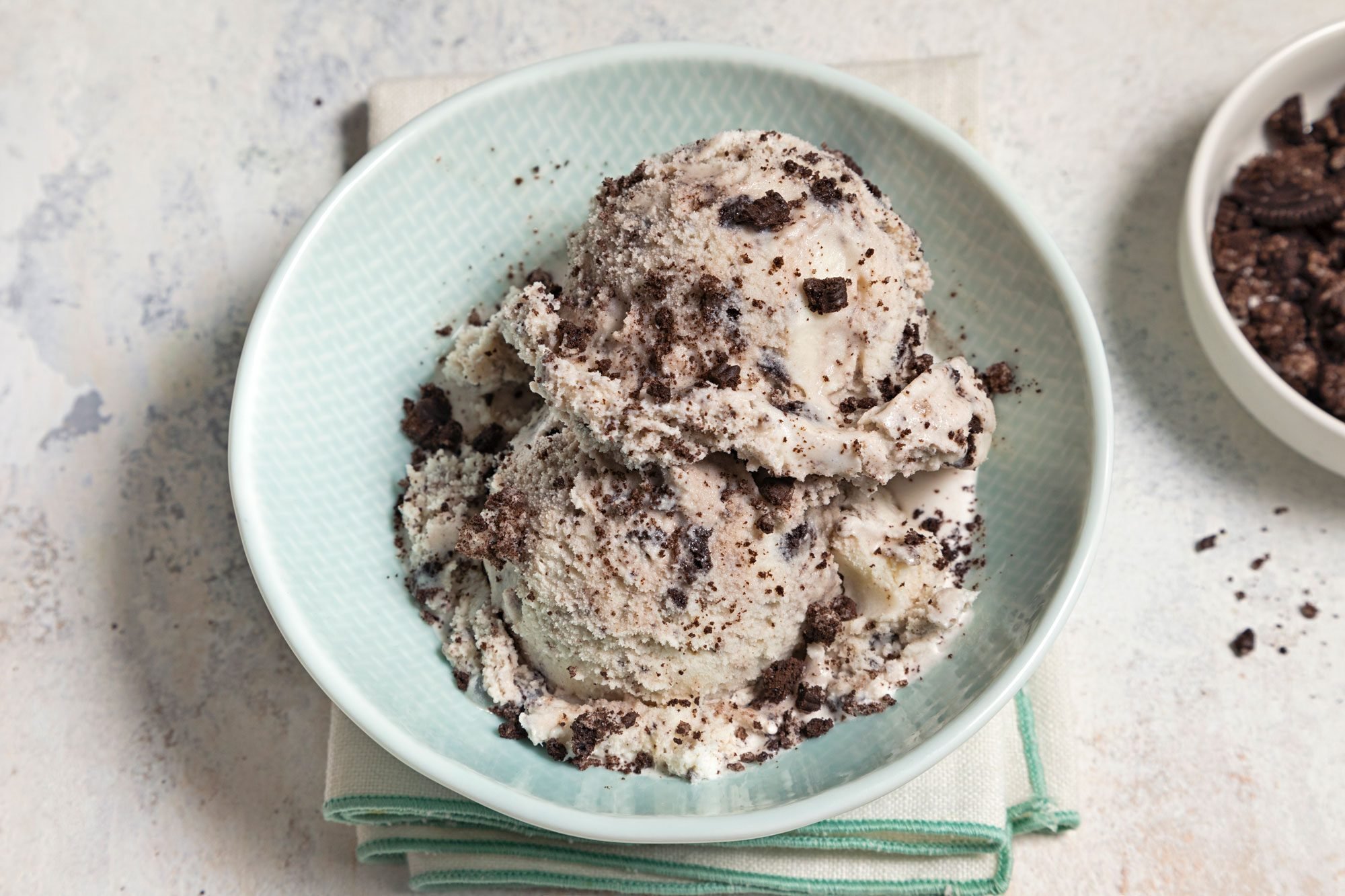 A bowl of Cookies and Cream Ice Cream topped with cookie crumbles
