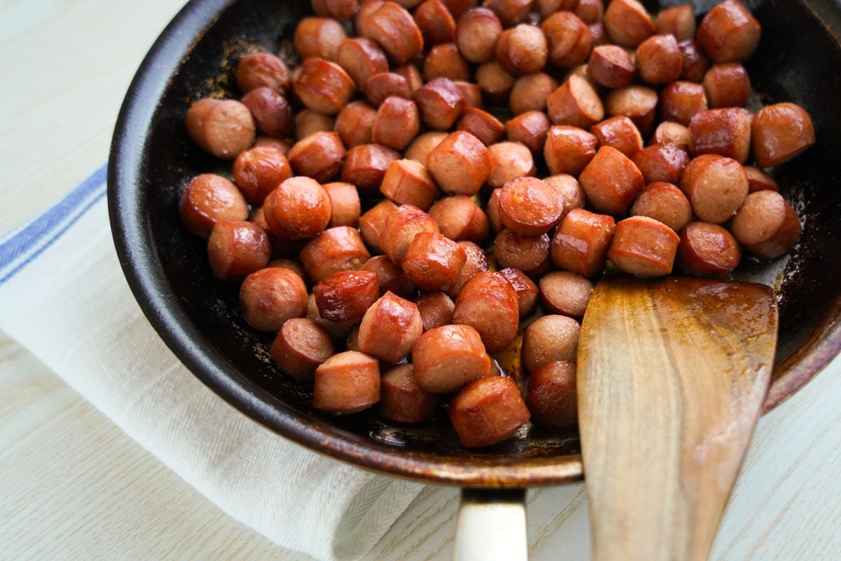 browning the hot dog pieces in a skillet