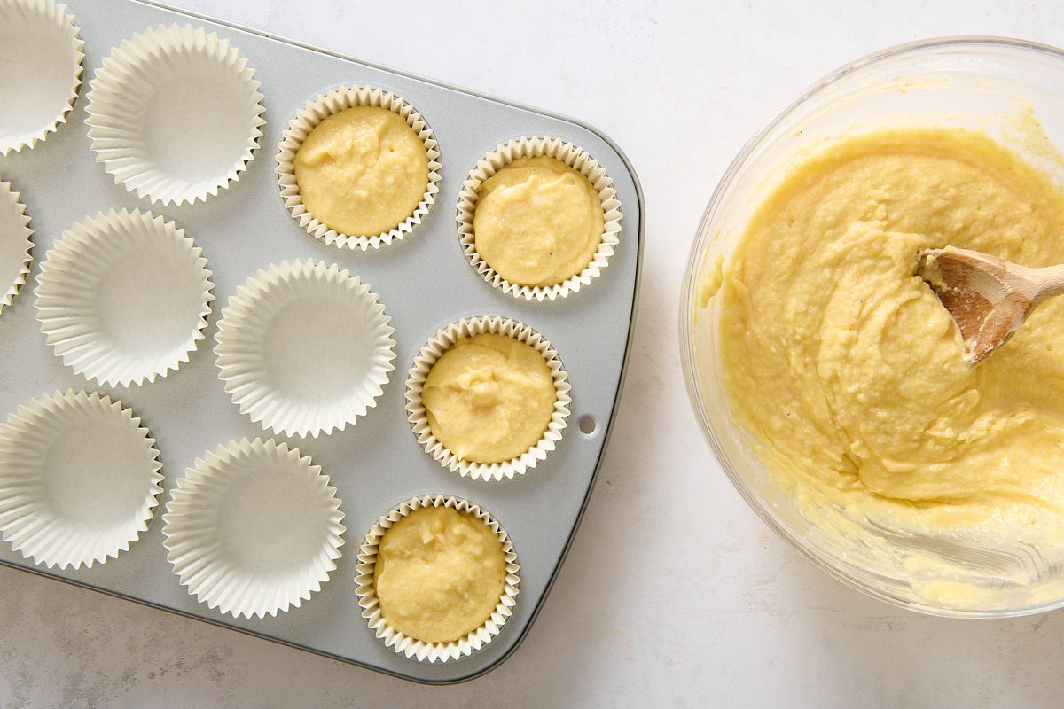 Spooning the batter into a paper case-lined muffin tray