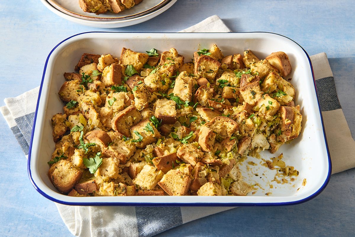 Gluten free stuffing in a baking dish with a portion removed