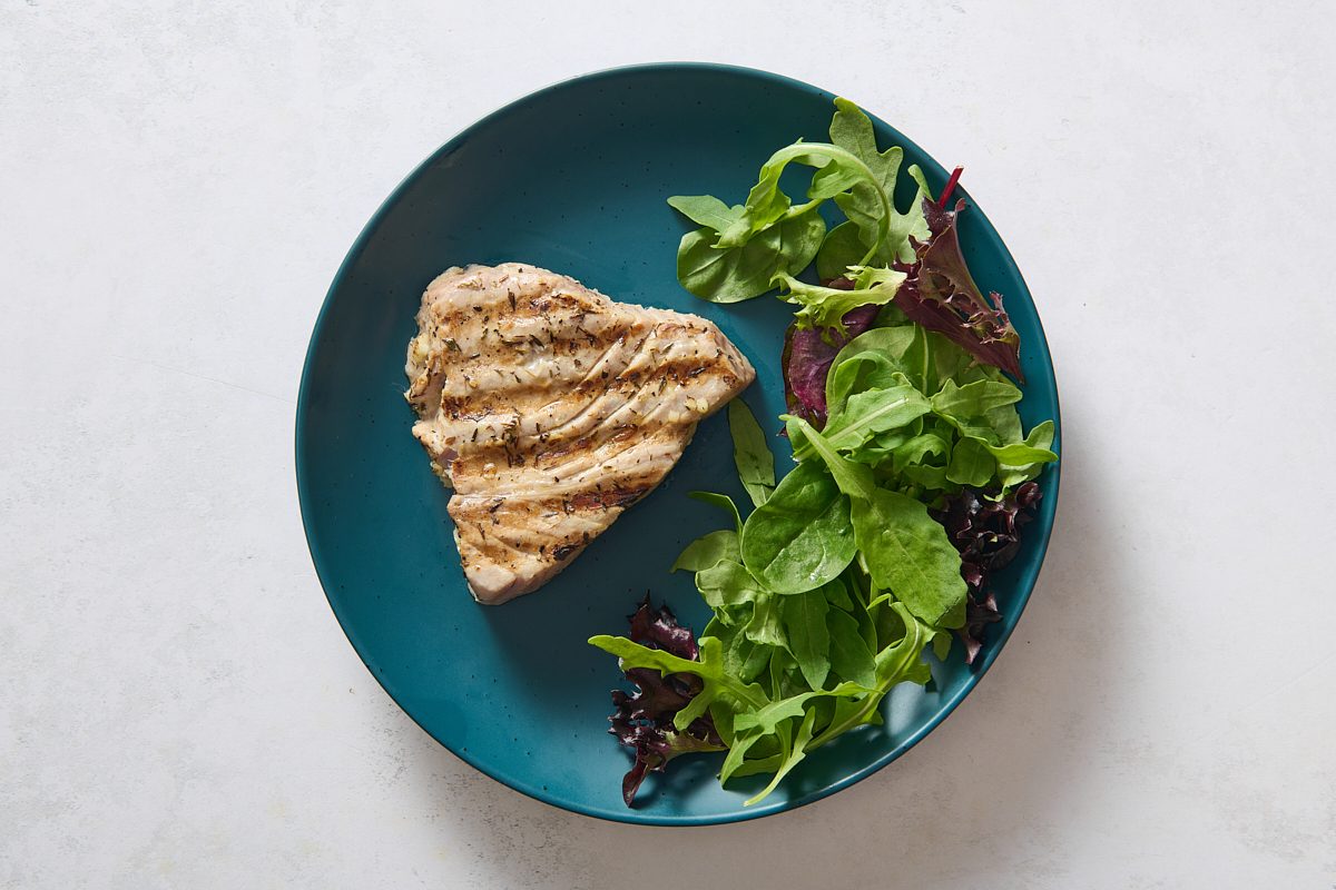 Serving the tuna on a plate with salad